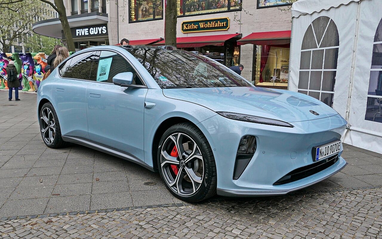 Light blue NIO ET5 sedan parked on a city street