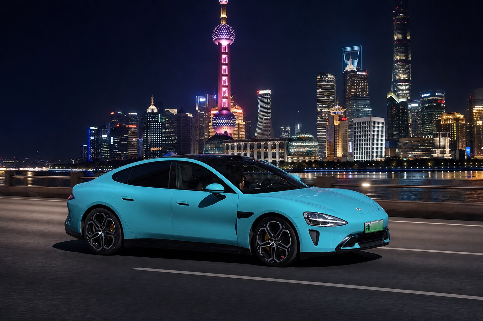 Electric car on the Bund with the Shanghai skyline lit up at night