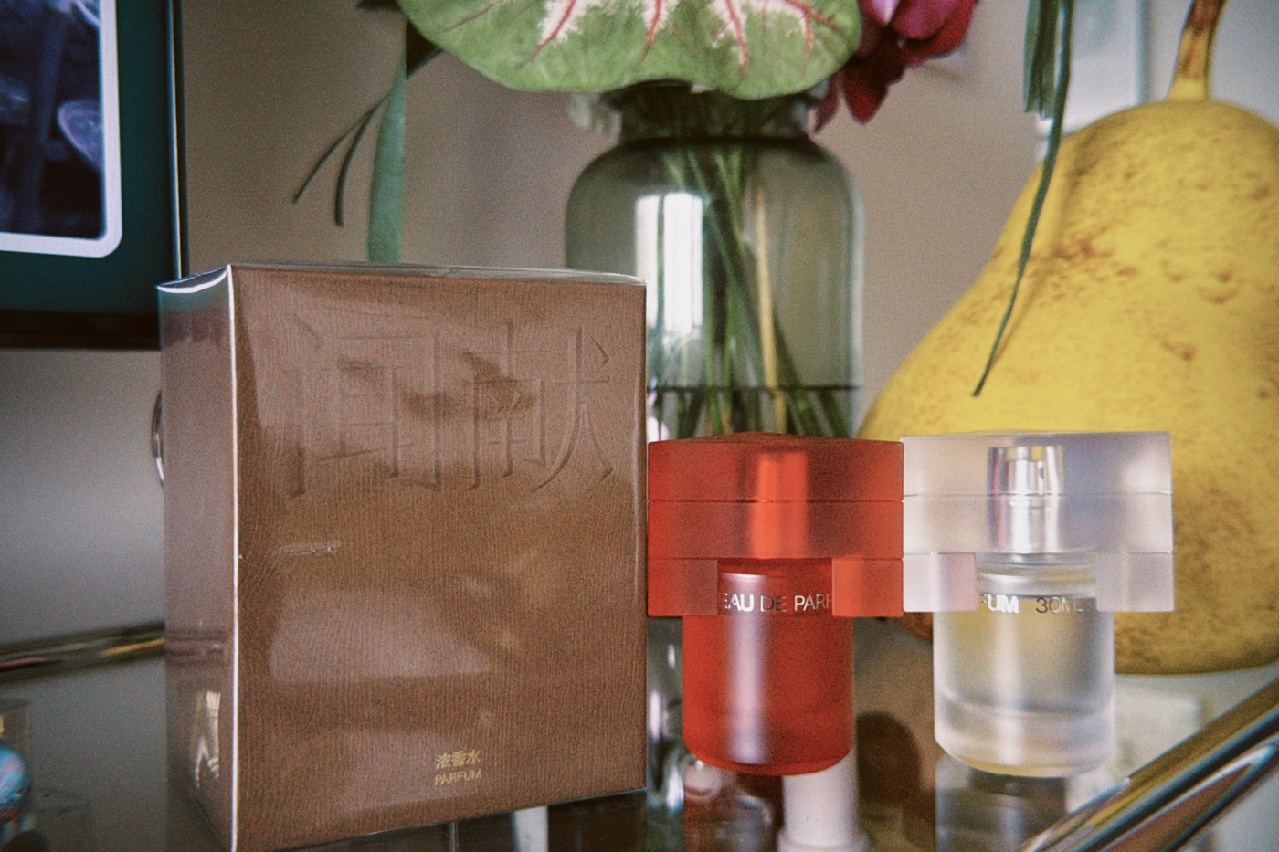 DOCUMENTS fragrance bottles and packaging on a shelf