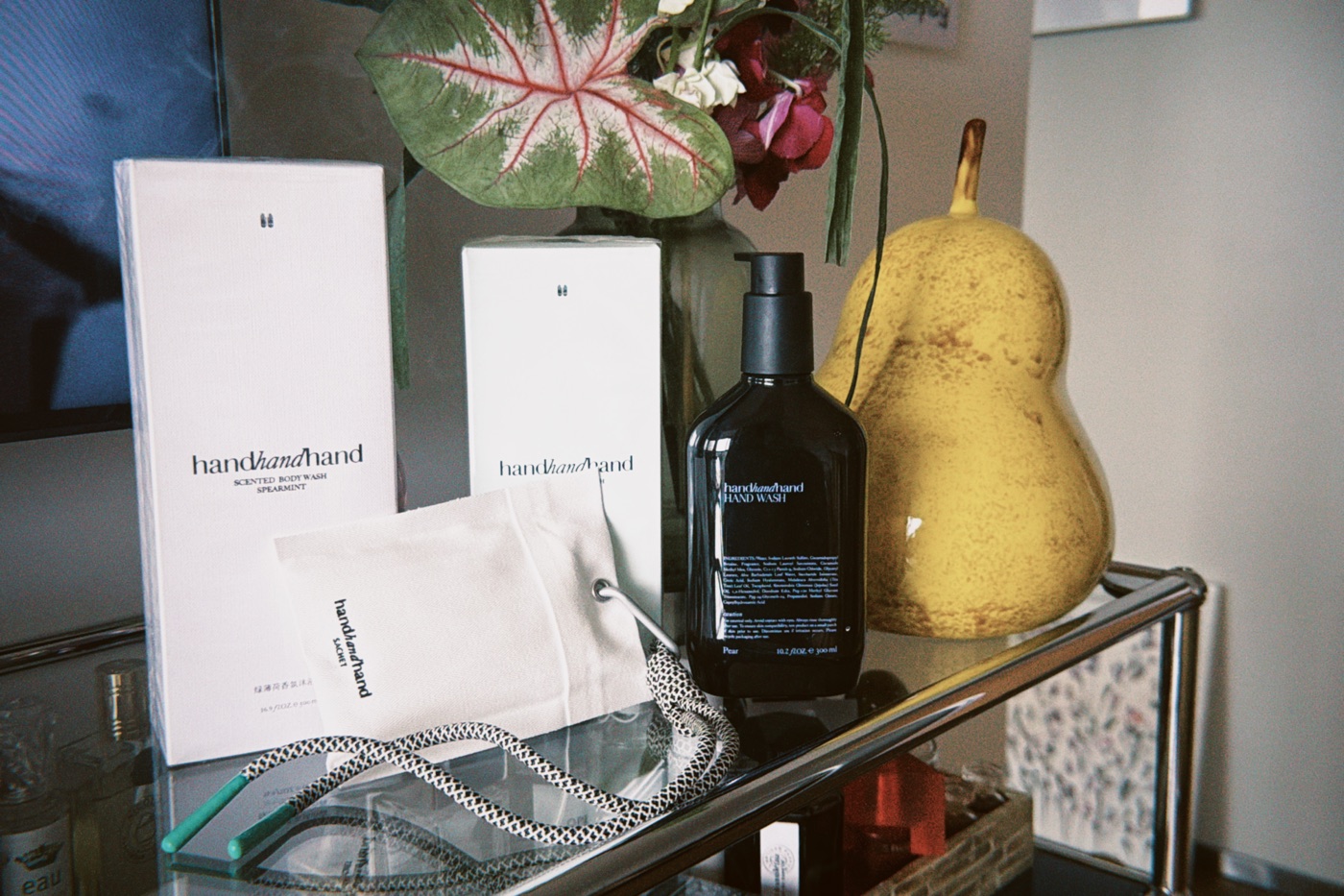 handhandhand wash products and a fabric sachet on a shelf