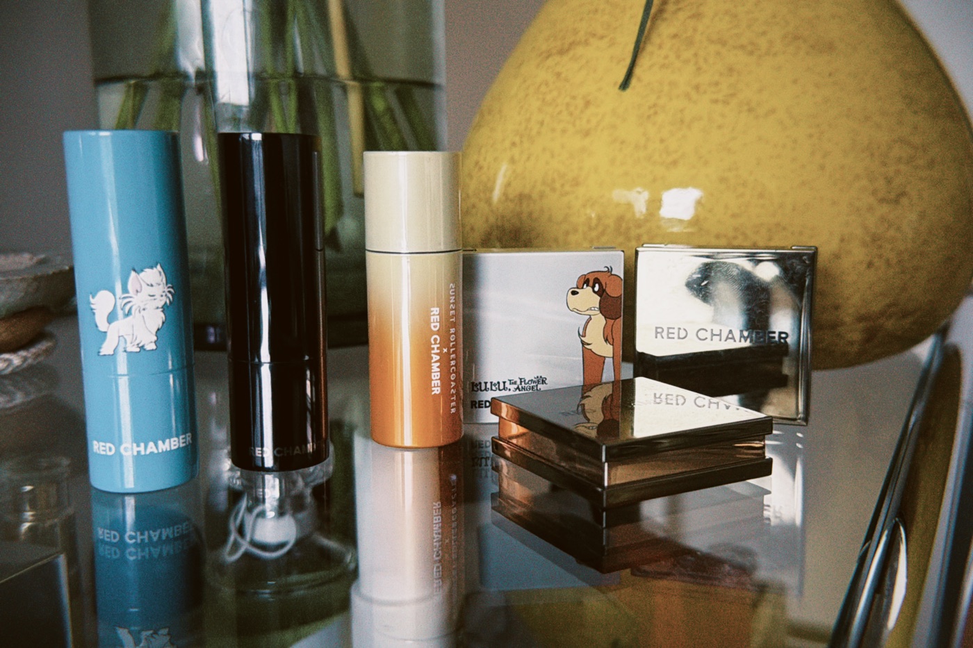 RED CHAMBER makeup sticks and compacts on a shelf
