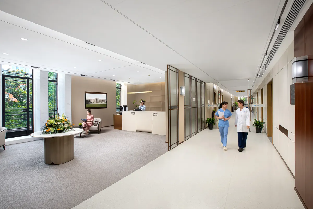 Bright outpatient corridor at United Family Healthcare with a doctor and nurse walking