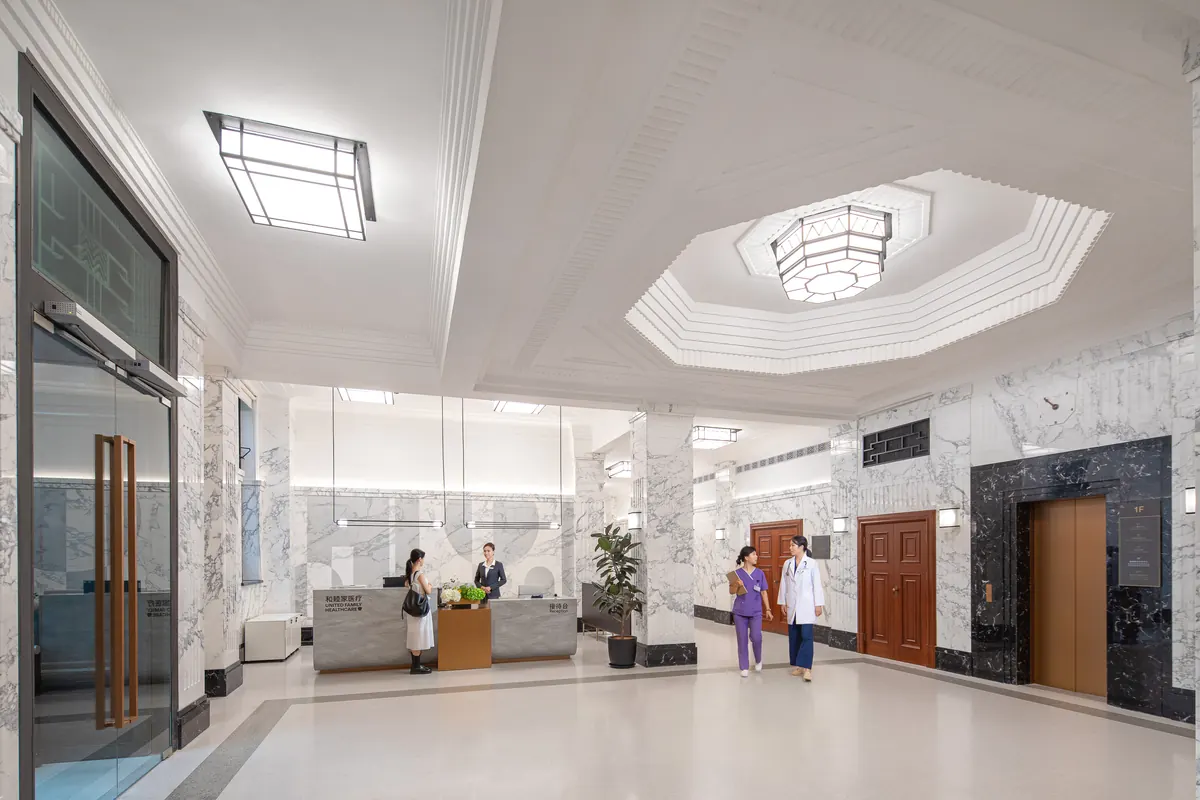Lobby of United Family Hospital with marble interiors, reception desk and clinical staff