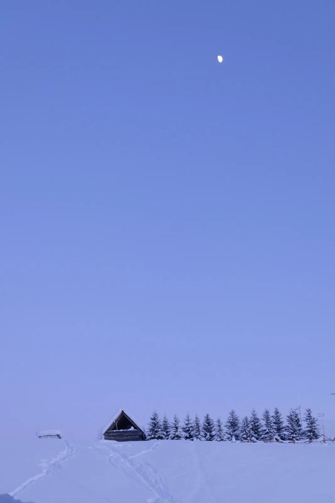 A winter dwelling beneath a wide evening sky