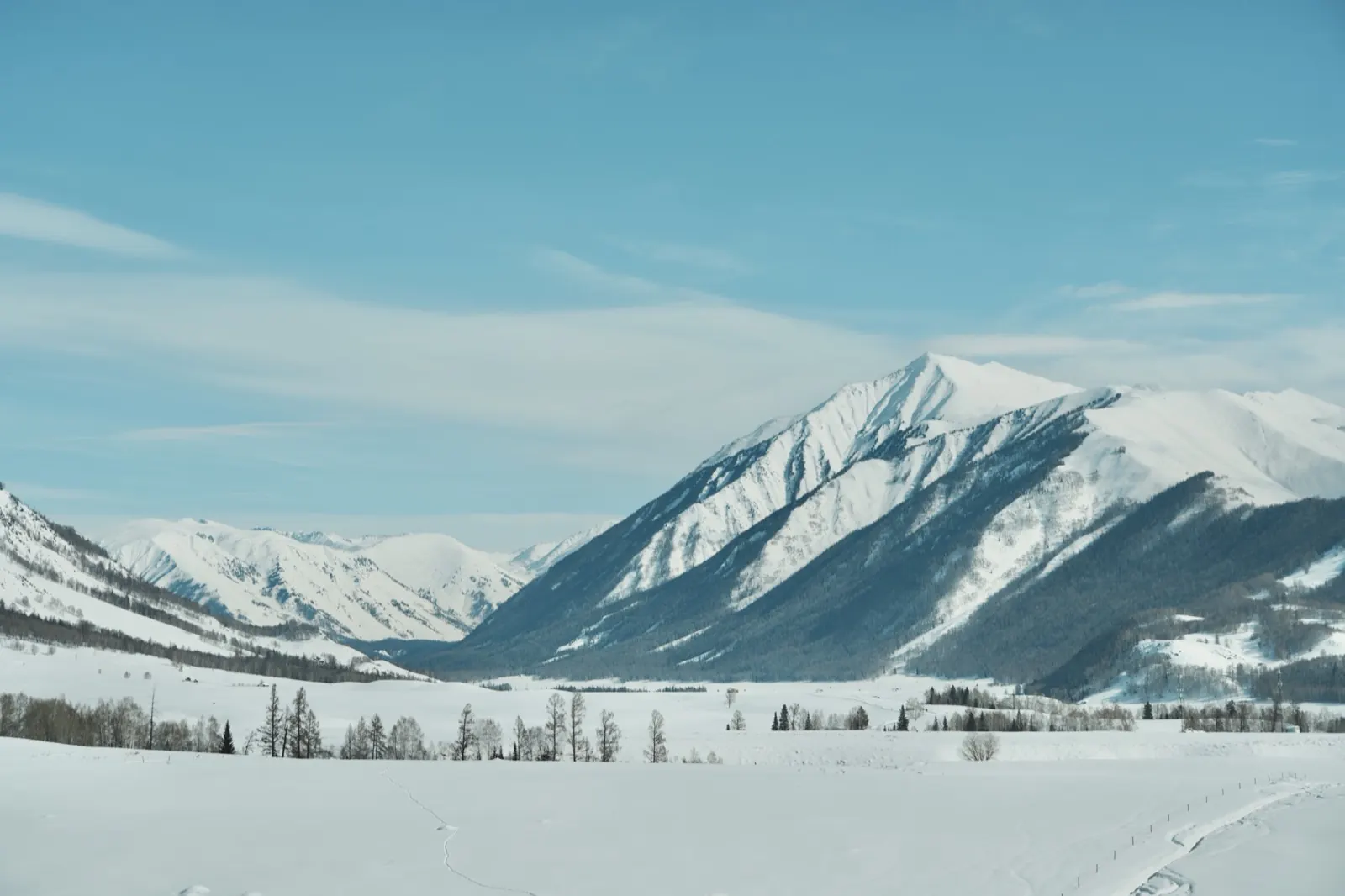 A broad snow-covered mountain landscape