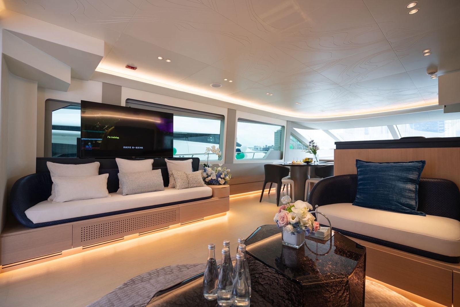 Blue and white sofas in the contemporary yacht’s indoor lounge
